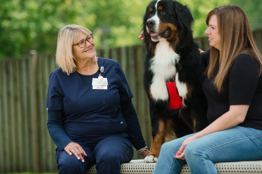 Nurse with patient and therapy dog